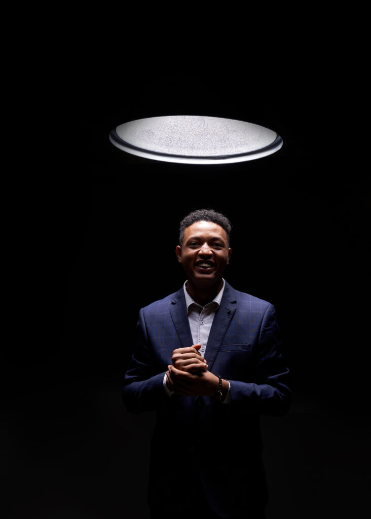 Image of royking niba coming out of the dark and standing under light to symbolize taking a business out of the dark using numerous digital marketing techniques