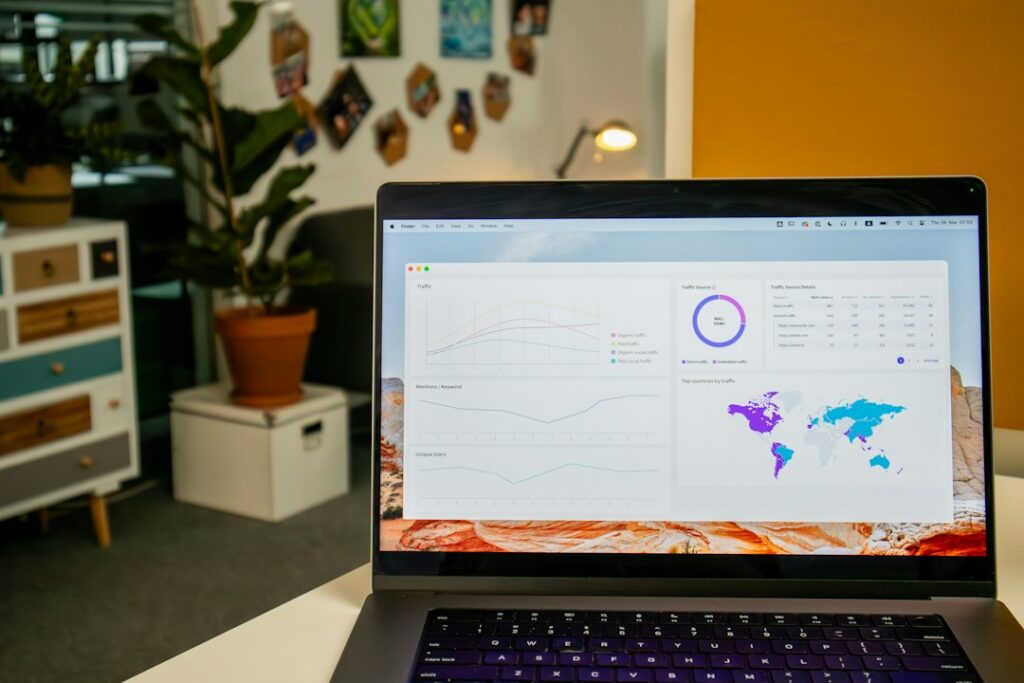 Stock photograph of a laptop on a desk showing an analytics dashboard. It is not a screenshot of any client's real reporting.