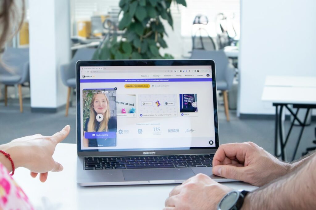 Stock photograph of two people looking together at a laptop screen, used to illustrate an article about ChatGPT citations