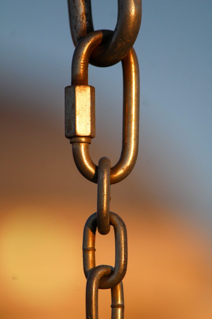 Stock photo of a metal chain link against a blurred background, illustrating links between websites