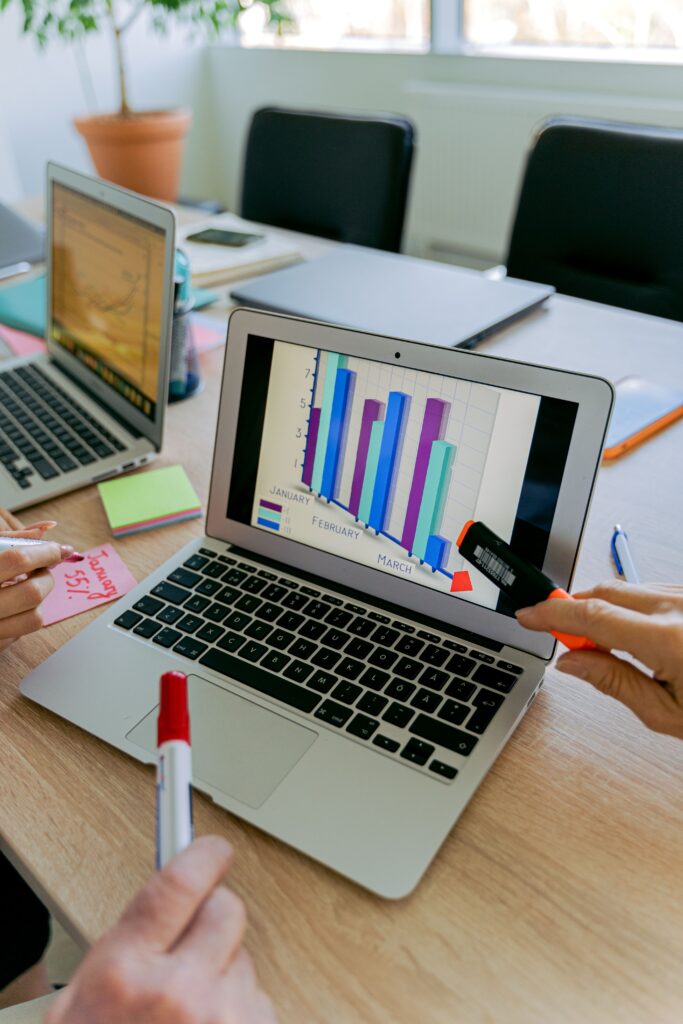 Stock photograph of a laptop on a wooden table showing a colourful graph. It is a generic stock image and not a screenshot of Search Console or any client report.