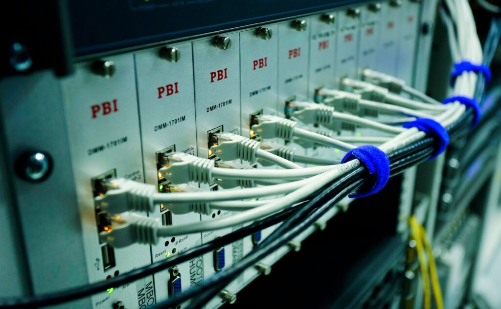 Stock photograph of ethernet cables plugged into a network switch panel. It is a generic stock image and not a photograph of any particular server or client infrastructure.