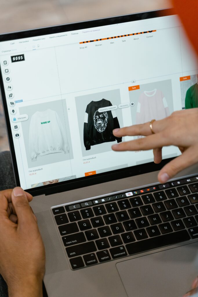 Stock photograph of hands browsing a shopping website on a laptop. Illustrative only, not a specific store or a client site.