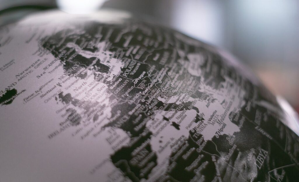 Stock photograph of a desk globe in greyscale. It is a licensed stock image and not a map of any particular site or market.